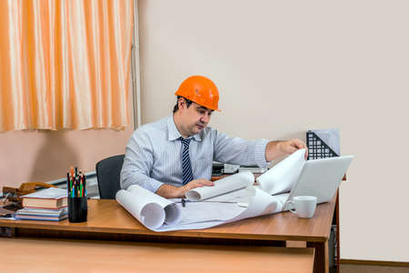 Adult male Project Manager checks the drawings. Architect at work. Checking drawings.の写真素材
