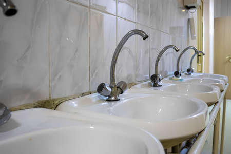 Leaking faucet in the sink. Water leak. Repair is required.の写真素材