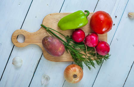 Vegetables on the kitchen table. Light wooden background. Close-up. Flat layの写真素材