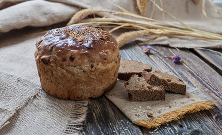 A loaf of bread on a wooden table. Authentic still life. The village plot. Close-up.の写真素材