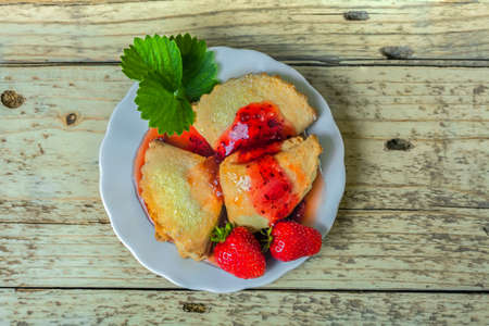 Cookies with berry jam. Baking with strawberries and currants. Sweet dessert with fruit syrup. Baking on a plate.の写真素材
