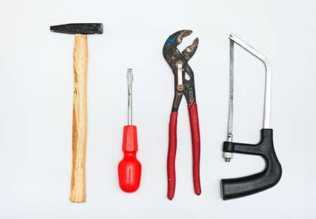 A set of metalwork tools. Hammer, screwdriver, hacksaw, adjustable wrench and screwdriver.の写真素材