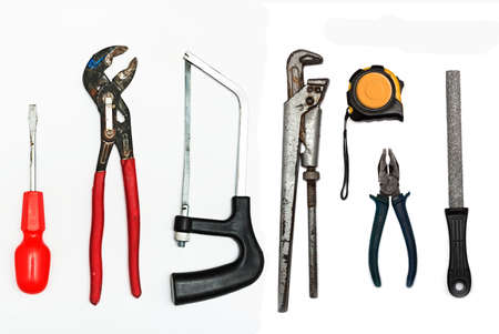 A set of metalwork tools. Hammer, screwdriver, hacksaw, tape measure, file, pliers, wrench and screwdriver.の写真素材