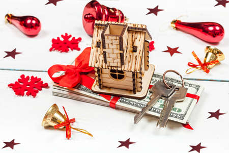 House, keys and a stack of banknotes. The idea of a gift for Christmas.の写真素材