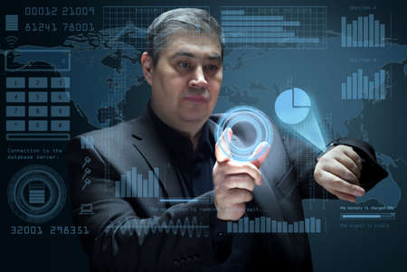 The businessman works with a futuristic virtual interface. Working with a virtual screen and managing business processes. Future technologies.の写真素材