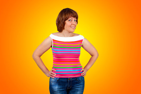 Beautiful young woman on an orange backgroundの写真素材