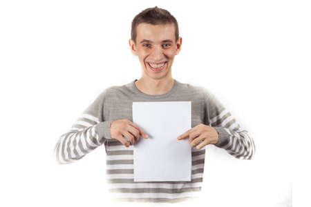 The young guy smiles in all his mouth and shows the blank placard. Mocup for advertising.の写真素材