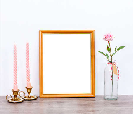 Minimalistic mockup 8x10 with pink candles and rose flower on gray rustic table. Portrait orientation.の写真素材