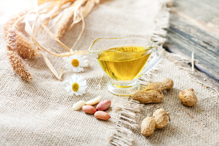 Peanut oil on a rustic table - wooden background and rough fabric