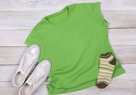 Green T-shirt on a Dark Wooden Background - Flat Lay, Ttop View, Mockupの写真素材