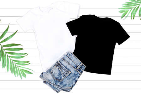 Black and White T-shirts Mockup - Flat Lay on a White Wooden Backgroundの写真素材