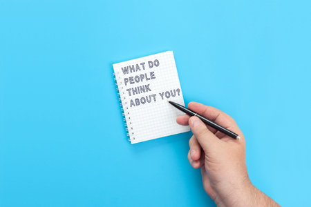 Hand with a pen writing in a notebook What Do People Think About You? Do you know how others judge...