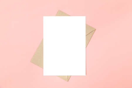 Wedding invitation or greeting card mockup. Blank white card 5x7 and craft paper envelope.の写真素材