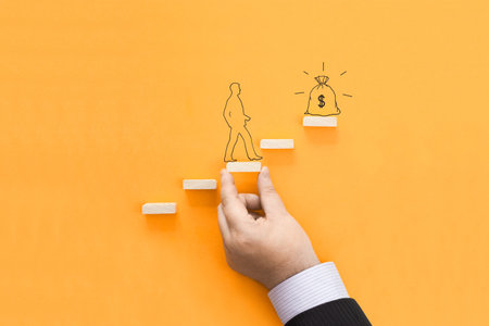 The concept of moving towards the goal. The little man climbs the steps.の写真素材