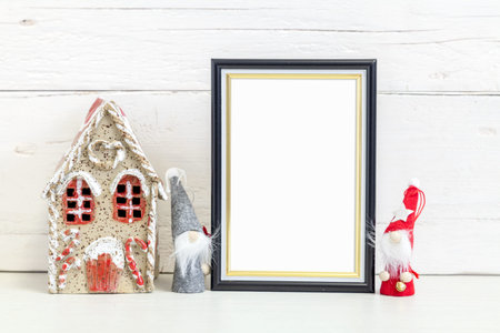 Black frame mockup. Black frame 10x15 on the table with holiday symbols.