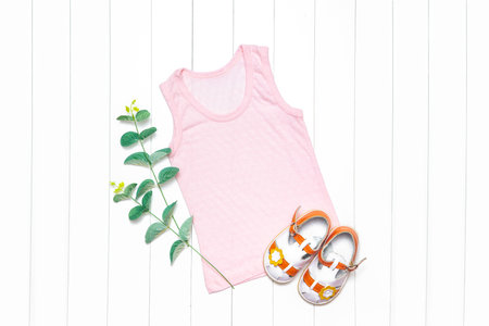 Mockup of a children's t-shirt. T-shirt with short sleeves on a white background with a sprig of eucalyptus.の写真素材