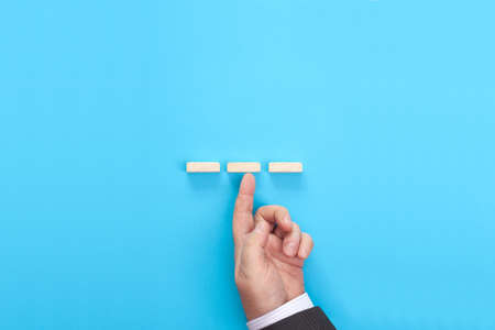 Hand of a businessman supporting wooden step. Business asset insurance and security concept.の写真素材