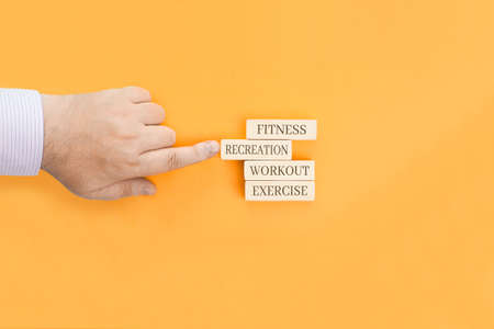Basic health concepts - words written on wooden blocks. Fitness, recreation, workout, exercise are concepts associated with a healthy lifestyle.の写真素材