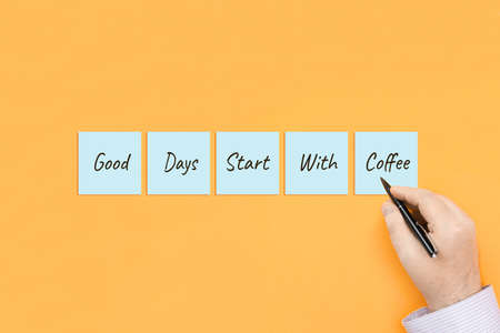 Motivational quote Good days start with coffee. Handwritten inscription on sticky notes.の写真素材
