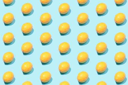 Summer background of yellow lemons on a mint table. Minimal fruit concept.の写真素材