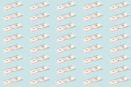 Creative background - dollar banknotes on a light mint background in even rows - an image on the theme of finance or businessの写真素材