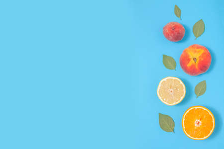 Blue summer background with tropical fruits - creative minimal compositionの写真素材