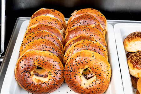 Freshly baked bagels with a golden brown crust and sesame seed topping. Warm and aromatic, straight...