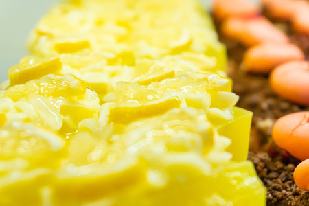 A close-up image of lemon jelly sweets garnished with lemon wedges - a sweet dessert elegantly...