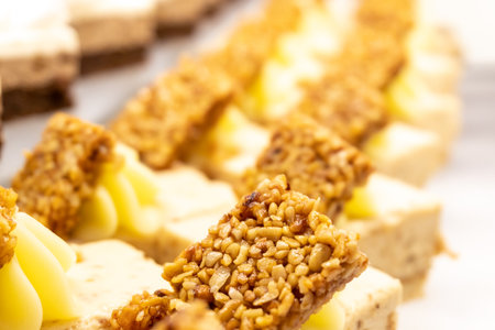 Cakes decorated with kozinaki and cream. Close-up. Restaurant menu. Creative photo. Selective focus.の写真素材
