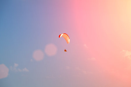 Performance of paragliders. A paraglider flies through the air on a paraglider. Soaring on a parachute.の写真素材
