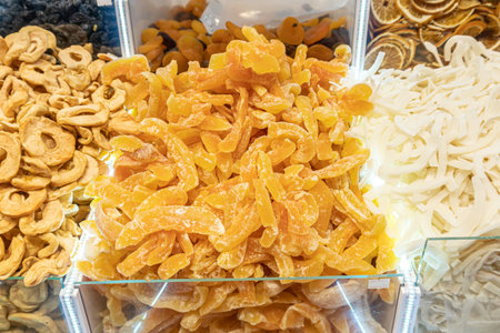 Dried fruits in eastern market. Pieces of candied melon. Dried melon. Eastern sweets. Candied melon. Close-up.の写真素材