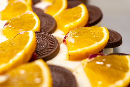 Cheesecakes decorated with orange slices and chocolate pieces. Close-up. Selective focus.の写真素材