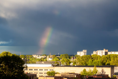 A fabulously beautiful view of a rainbow against a dark stormy sky. Rainbow after a thunderstorm.の写真素材
