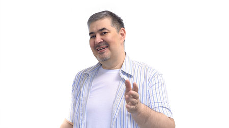 The man looks at the camera in surprise. He is perplexed. Emotions of surprise and confusion.