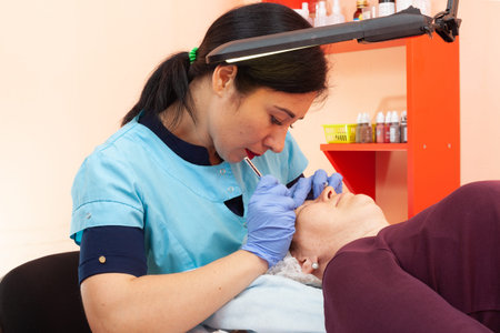 Permanent eyebrow makeup. A cosmetologist performs microblading. Eyebrow correction. Close-up....