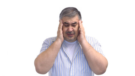 Tired man rubs his temples. Headache. Image isolated on white background.の写真素材