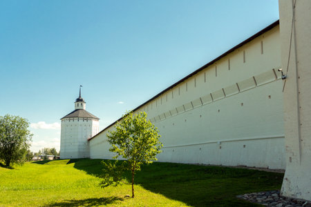 The walls of the Kirillo-Belozersky Monastery. Narrow loopholes and a watchtower. A monument of medieval architecture.の写真素材