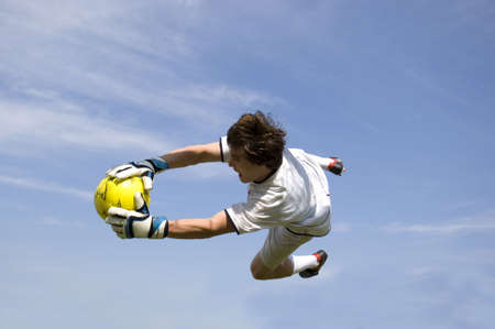 Soccer - Football Goal Keeper Making Diving Saveの写真素材