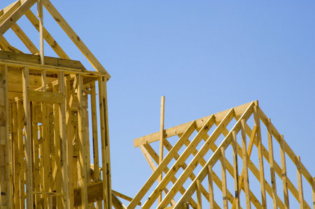 House under construction against blue sky