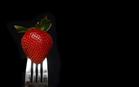 Strawberry on Fork on Blackの写真素材