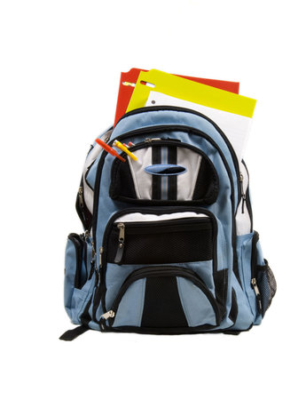 Blue school back pack full of school supplies with paper, folders and pencils