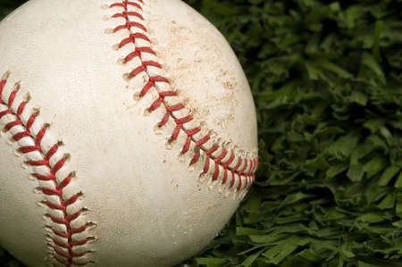 Baseball laying on grass closeupの写真素材