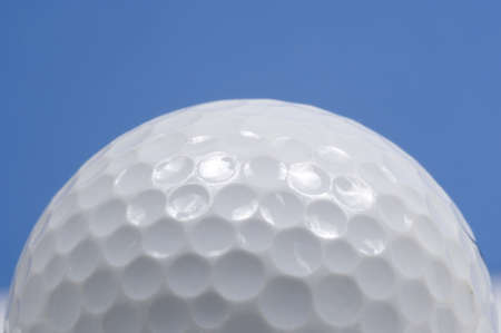 golf ball close up with blue skyの写真素材