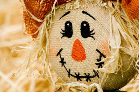 Autumn, fall decoration at pumplin patch featuing a scarecrow and wagon with strawの写真素材