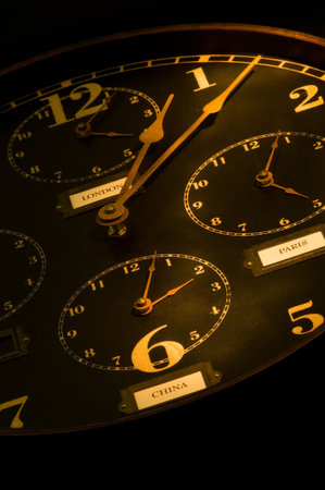 vintage clock with multiple faces depicting time in different parts of the world light painted with...