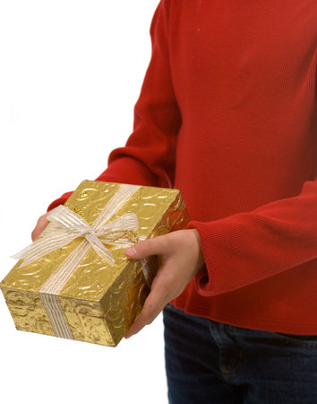 Young gil in red sweater presenting Christmas gift wrapped in gold, shallow depth of field with...