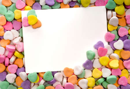 white notecard surrounded by candy conversation hearts- blankの写真素材