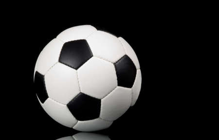 football - soccer ball on black background with reflectionの写真素材