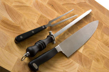 professional chefs, cooks meat carving set on wood block cutting surfaceの写真素材