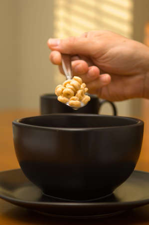 Fast breakfast consiting of oat cereal and coffee with creamerの写真素材